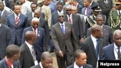 Zimbabwe's President Robert Mugabe (C) and Mozambique's President Armando Guebuza (2nd L red tie) arrive with other regional leaders for a summit of the Southern African Development Community in Mozambique's capital Maputo, August 17, 2012.