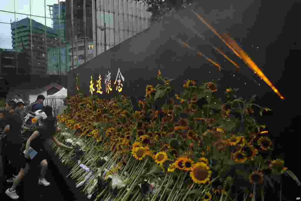 Attendees take part in a public memorial for Marco Leung, the 35-year-old man who fell to his death weeks ago after hanging a protest sign against an extradition bill, in Hong Kong.