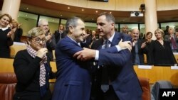 Gilles Simeoni, right, is congratulated by newly elected President of the Corsican Assembly Jean-Guy Talamoni as he celebrates after being elected president of the Corsican Executive Council in the Corsican Assembly in Ajaccio, on the French Mediterranean island of Corsica, Jan. 2, 2018.