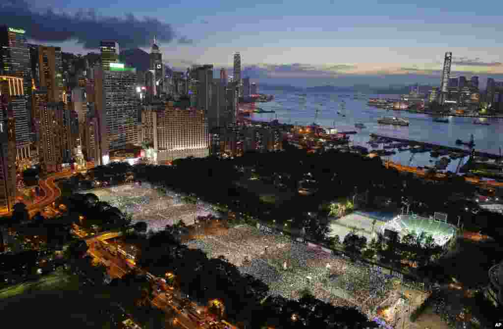 Tens of thousands of people attend a candlelight vigil at Victoria Park in Hong Kong to mark the 25th anniversary of crackdown in Tiananmen Square, June 4, 2014. 