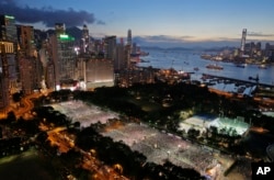 FILE - Tens of thousands of people attend a candlelight vigil at Victoria Park in Hong Kong to mark the 25th anniversary of crackdown in Tiananmen Square, June 4, 2014.