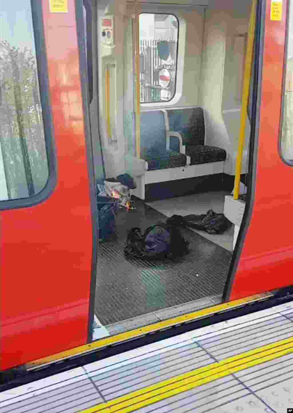 This is an image made from video showing burning items in underground train at the scene of an explosion in London Friday, Sept. 15, 2017.