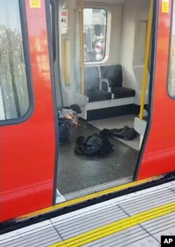 This is an image made from video showing burning items in underground train at the scene of an explosion in London Friday, Sept. 15, 2017.