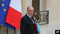 FILE - French Interior Minister Bernard Cazeneuve leaves the Elysee Palace following a weekly Cabinet meeting in Paris, May 2014.