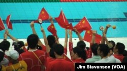 Chinese fans cheer at the Water Cube in Beijing.