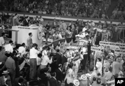 FILE - Sen. Joseph McCarthy (left, on rostrum) addresses the Republican convention, July 9, 1952, defending his tactics in opposing communism against charges of those who said he was too rough.