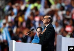 FILE - Khizr Khan, father of fallen US Army Capt. Humayun S. M. Khan, speaks while his wife Ghazala Khan looks on, during the final day of the Democratic National Convention in Philadelphia, July 28, 2016.