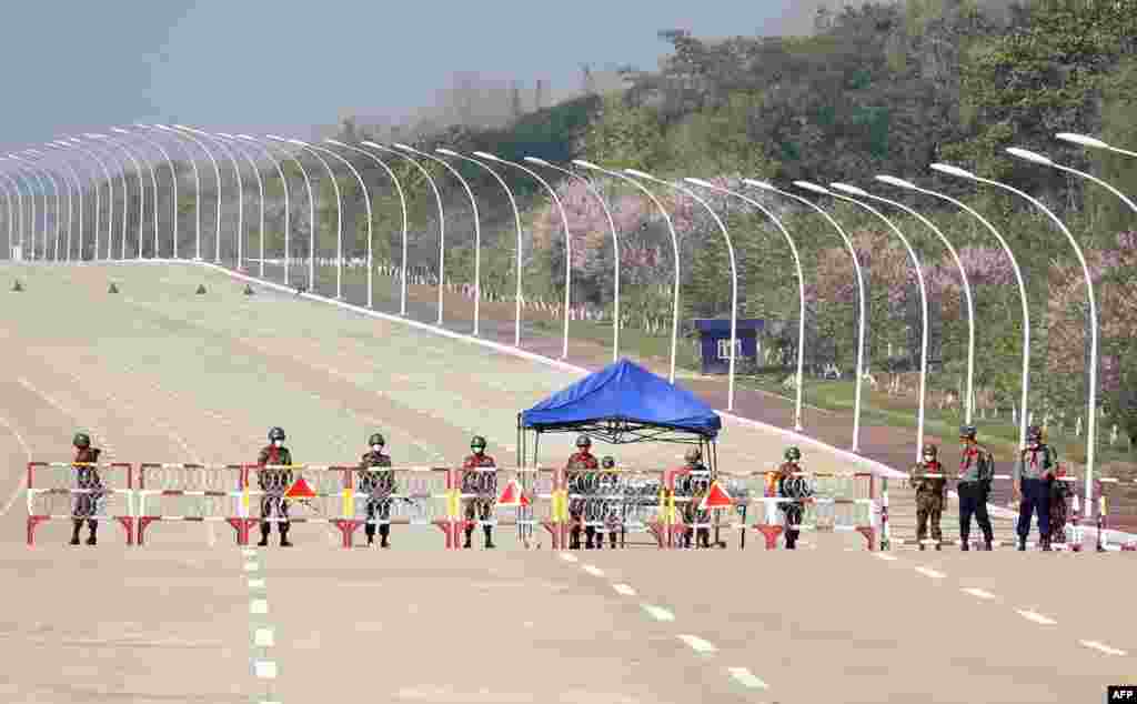 Soldiers stand guard on a blockaded road to Myanmar&#39;s parliament in Naypyidaw&nbsp; after the military detained the country&#39;s de facto leader Aung San Suu Kyi and the country&#39;s president in a coup.