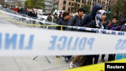 Para pelajar New York masuk sekolah seperti biasa melewati kawasan yang diberi tanda penghalang oleh polisi di dekat lokasi serangan di Manhattan bawah, Rabu (1/11). 