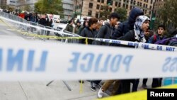 Students walk past police line tape on their way to school a day after a man driving a rented pickup truck mowed down pedestrians and cyclists on a bike path alongside the Hudson River in New York City, New York, Nov. 1, 2017.