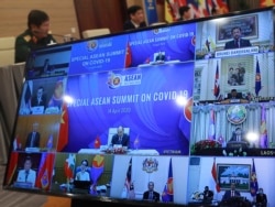 A TV screen shows Vietnamese Prime Minister Nguyen Xuan Phuc, center, addressing the Special ASEAN summit on COVID-19 in Hanoi, Vietnam Tuesday, April 14, 2020.