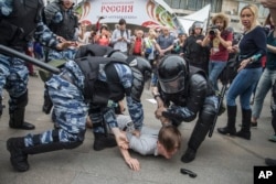 Police detain a protester in Moscow, Russia, June 12, 2017.