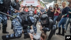 Police detain a protester In Moscow, Russia, June 12, 2017.