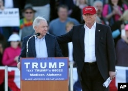 FILE - Republican presidential candidate Donald Trump, right, stands next to Sen. Jeff Sessions, R-Ala., as Sessions speaks during a rally in Madison, Alabama, Feb. 28, 2016.