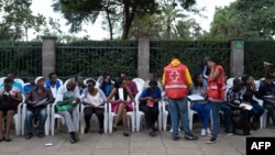 People wait to donate blood at the August 7th Memorial Park, where a 1998 terrorist bomb attack took place at the then U.S. Embassy, in Nairobi, Jan. 16, 2019, a day after a blast followed by a gun battle that rocked an upmarket hotel complex.