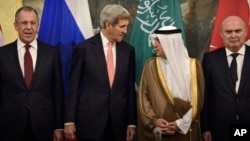 From left, Russian Foreign Minister Sergei Lavrov, Secretary of State John Kerry, Saudi Foreign Minister Adel al-Jubeir and Turkish Foreign Minister Feridun Sinirlioglu stand together before a meeting in Vienna, Austria, Oct. 29, 2015.