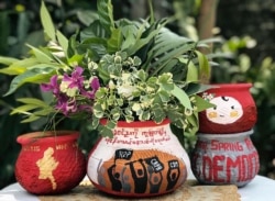 This photo taken and received courtesy of an anonymous source via Facebook on April 13, 2021 shows Thingyan festival flowers and leaves displayed in pots decorated with designs in support of demonstrations by protesters against the military coup in Yangon
