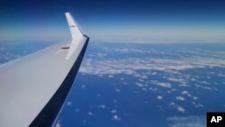 Japan Coast Guard's Gulfstream V aircraft flies in the search zone for debris from the missing Malaysia Airlines flight MH370, April 1, 2014 off Perth, Australia.