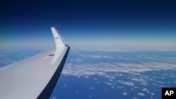 FILE - Japan Coast Guard's Gulfstream V aircraft flies in the search zone for debris from the missing Malaysia Airlines flight MH370.