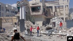 Rescuers and security forces sift through wreckage at the scene of a blast in Mogadishu, Somalia, Jan. 12, 2022.