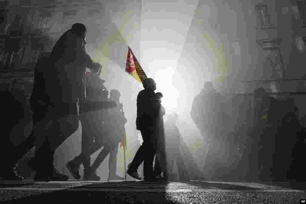 Protesters march during a demonstration in Lyon, France.