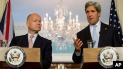 U.S. Secretary of State John Kerry gestures as he speaks during a joint news conference with British Foreign Secretary William Hague at the State Department, Jun. 12, 2013.