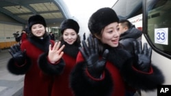 North Korean cheering squads wave upon their arrival at the Korean-transit office near the Demilitarized Zone in Paju, South Korea, Feb. 7, 2018. 