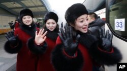 North Korean cheering squads wave upon their arrival at the Korean-transit office near the Demilitarized Zone in Paju, South Korea, Feb. 7, 2018.