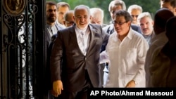 Iranian Foreign Minister Mohammad Javad Zarif, left, is welcomed by Cuban Foreign Minister Bruno Rodriguez, in Havana, Cuba, Aug. 22, 2016. 