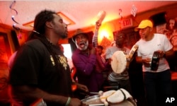 Members of the Mowhawk Hunters, a Mardi Gras Indian tribe, and the only tribe on the city's west bank of the Mississippi River, practice inside Sheila's Fantasy Lounge in New Orleans, Jan. 3, 2016.