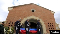 FILE - Guards of the presidency carry the casket of a soldier killed in an rebel attack after during his funeral at army school in Bogota, Oct. 29, 2015. 