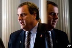 Republican presidential candidate, New Jersey Gov. Chris Christie talks as he meets with a supporter before a news conference, Jan. 25, 2016, in Concord, New Hampshire.