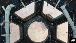 This image is the first taken through a first of its kind "bay window" on the International Space Station, the seven-windowed Cupola. The image shows the Sahara Desert spread out through the array of windows