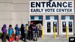 A line of early voters waits outside the Franklin County Board of Elections, Nov. 7, 2016, in Columbus, Ohio. Heavy turnout has caused long lines as voters take advantage of their opportunity to vote before election day.