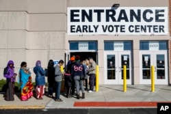 A line of early voters waits outside the Franklin County Board of Elections, Monday, Nov. 7, 2016, in Columbus, Ohio. Heavy turnout has caused long lines as voters take advantage of their opportunity to vote before election day.