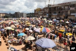 FILE - People shop at Mokolo market in Yaounde, Cameroon.