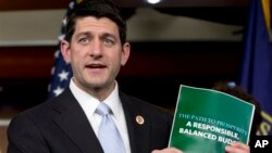 FILE- Congressman Paul Ryan holds a copy of the 2014 Budget Resolution, March 2013.