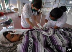 FILE - A Hepatitis-B patient Bharat Prajapati, 21, receives medical treatment at an isolation ward of the Civil hospital in Ahmadabad, India.