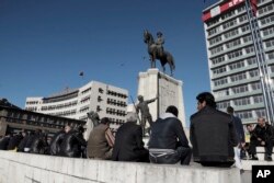 Unemployed people sit around a statue of Turkey's founder, Mustafa Kemal Ataturk, days before the April 16 referendum, in Ankara, March 22, 2017. Turkish President Recep Tayyip Erdogan ramped up his anti-European rhetoric on Wednesday, warning that the safety of Western citizens could be in peril if European nations persisted in what he described as arrogant conduct.