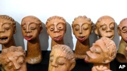 FILE - Lilian Nabulime's clay sculpture pieces exhibited during the "Olugamba exhibition at Xenson Art Space in Kamwokya, Kampala, Uganda, November 28, 2023.