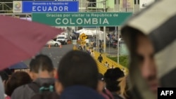 FILE - Venezuelan citizens wait to cross to Ecuador at the Rumichaca international bridge in Ipiales, Colombia, on Aug. 11, 2018. Ecuador's President Daniel Noboa announced on Feb. 3, 2025, a three-day border closure to coincide with elections.