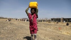 A girl carries a canister of cooking oil she received from the local charity Mona Relief at a camp for internally displaced people on the outskirts of Sana'a, Yemen March 1, 2021.