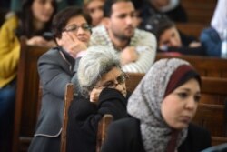 Laila Soueif (C), the mother of Alaa Abdel Fattah, attends the retrial of her son and 24 others, in the courtroom in Cairo on December 27, 2014.