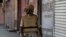 FILE- In this Thursday, Aug. 22, 2019 photo, a Kashmiri policeman patrols outside closed shops in Srinagar, Indian-controlled Kashmir.