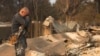 Cesar Plaza becomes emotional while looking at his home destroyed by the Eaton Fire in Altadena, California, Jan. 9, 2025.