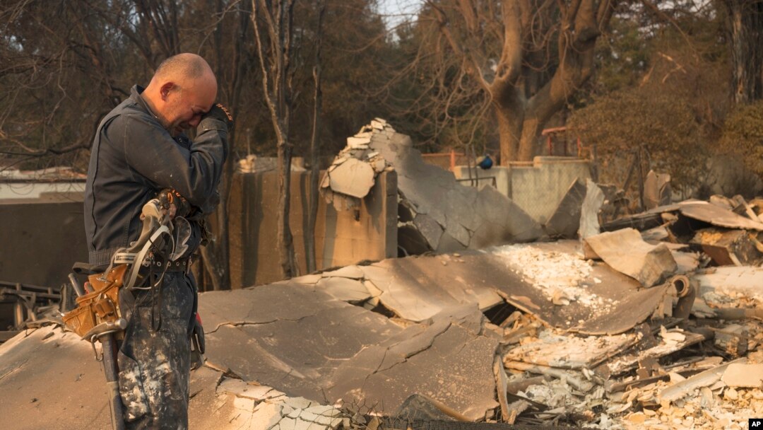 Cesar Plaza becomes emotional while looking at his home destroyed by the Eaton Fire in Altadena, California, Jan. 9, 2025.