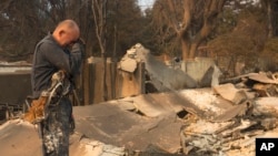 Cesar Plaza becomes emotional while looking at his home destroyed by the Eaton Fire in Altadena, California, Jan. 9, 2025.