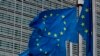 FILE—European Union flags flap in the wind outside EU headquarters in Brussels, October 16, 2019.