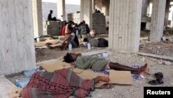 Ethiopian migrants sleep in an under-construction building in Aden, Yemen, June 15, 2020.