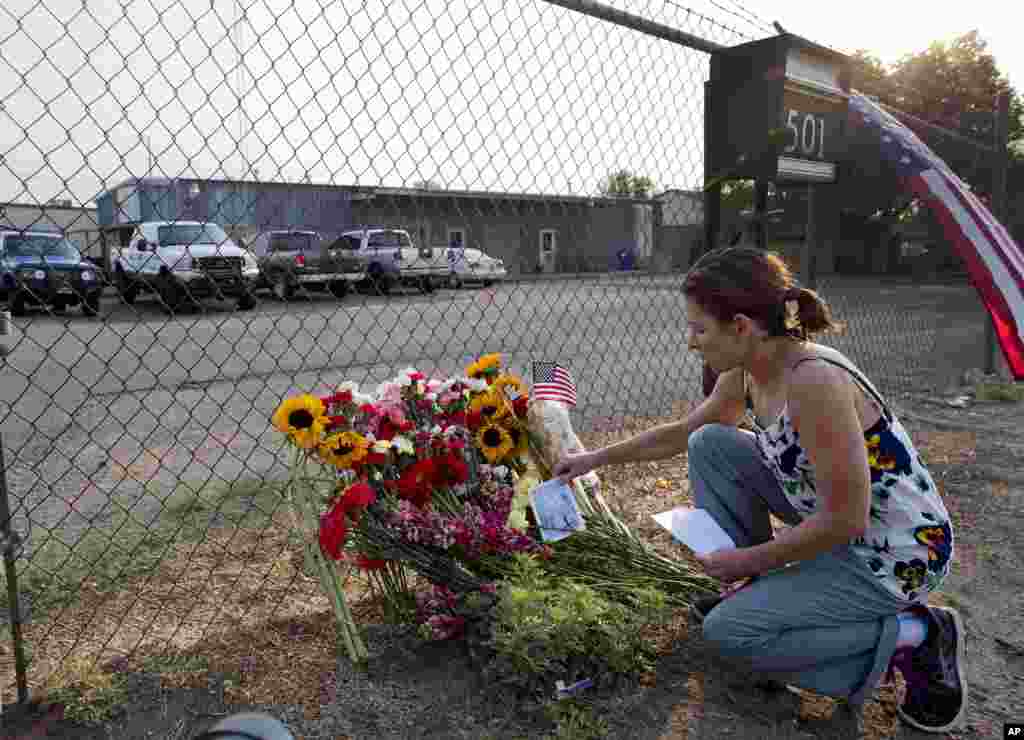 Toby Schultz lays flowers at the gate of the Granite Mountain Hot Shot Crew fire station, July 1, 2013, in Prescott, Ariz.